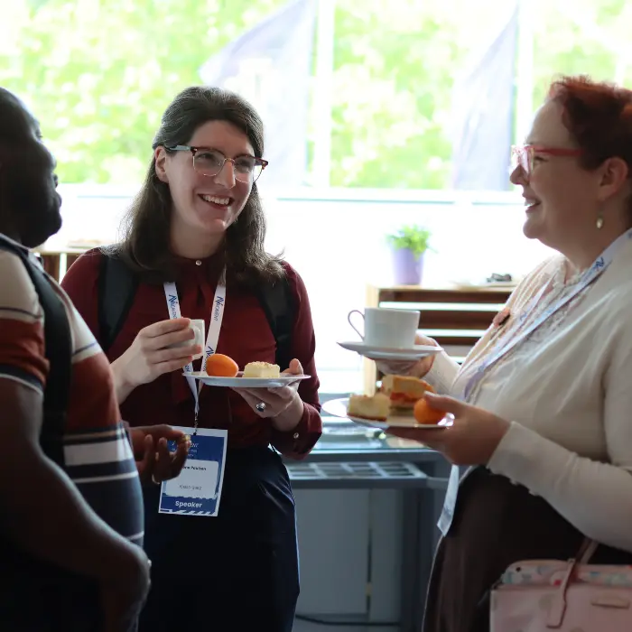 Delegates chatting over coffee during a break at a past Acavent conference