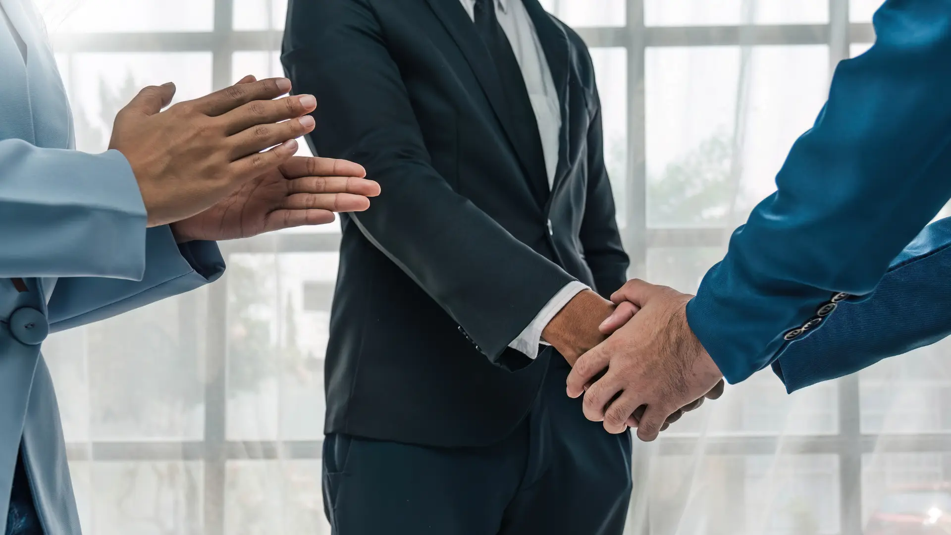 Business partners shaking hands to mark a partnership